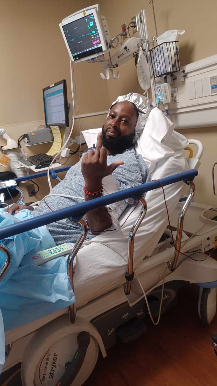 John Stephens recovering in a hospital bed